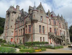 un grand château avec des fleurs devant dans l'établissement New 4 stars Large prime city center 2 bed 2 bath duplex apartment with free secure parking, à Belfast