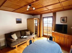 a living room with a couch and a tv at Lexhof in Sellrain