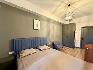 a bedroom with a large bed and a chair at ''Malibu'' Apartment with 2 Bedrooms and Open Balcony, Yerevan CITY CENTER-Buzand Street in Yerevan
