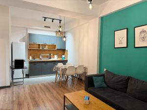 a living room with a couch and a table at ''Malibu'' Apartment with 2 Bedrooms and Open Balcony, Yerevan CITY CENTER-Buzand Street in Yerevan