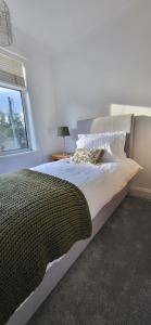 a bedroom with a large bed with a window at The Willows in Stockton-on-Tees