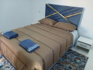 a bed with two pillows on it in a room at Maison almassira in Agadir