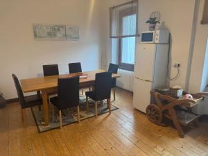 a dining room with a table and a refrigerator at Olga Apartment in Traben-Trarbach