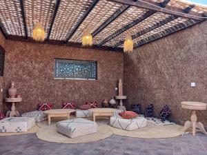 a room with couches and tables in a building at Maison almassira in Agadir