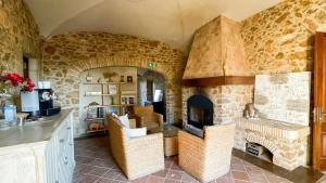 a kitchen with a stone fireplace in a room at Hotel Molí de l'Escala in L'Escala