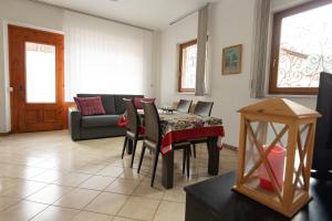 a living room with a table and a couch at Capole7 in Valdidentro