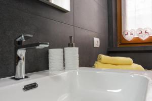 a bathroom sink with a faucet and some towels at Capole7 in Valdidentro +17 photos