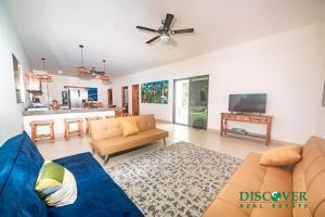 a living room with a couch and a tv at Nica Nest 3Br Eco Home Escamequita, NI in San Juan del Sur