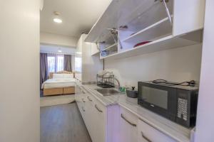 a kitchen with a sink and a microwave at Oldcity homes hotel in Istanbul