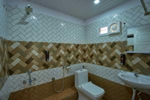 a bathroom with a toilet and a sink at The Panakal Boho in Cochin +26 photos