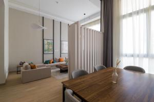 a living room with a table and a couch at Brassbell l Sheikh Zayed l Aeon Towers in Cairo
