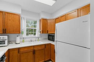 a kitchen with wooden cabinets and a white refrigerator at John Wayne View cabin in Del Rio