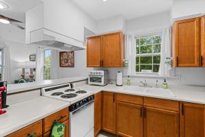 a kitchen with wooden cabinets and a white stove top oven at John Wayne View cabin in Del Rio +38 photos