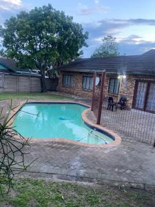 a swimming pool in the yard of a house at Blissful Breeze in Richards Bay