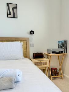 a bedroom with a bed and a table with a radio at Eco-Friendly Highland Suite with Mountain Views in Spean Bridge