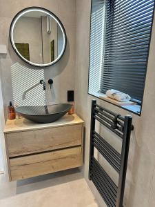 a bathroom with a sink and a mirror at Eco-Friendly Highland Suite with Mountain Views in Spean Bridge +37 photos