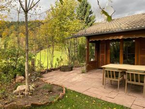 a patio with a picnic table and a house at Ruhige Hütte mit toller Aussicht in Dammbach