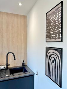 a kitchen with a sink and a picture on the wall at Eco-Friendly Highland Suite with Mountain Views in Spean Bridge