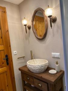 a bathroom with a sink and a mirror at Ruhige Hütte mit toller Aussicht in Dammbach