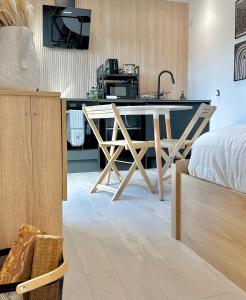 a kitchen with a table and a sink in a room at Eco-Friendly Highland Suite with Mountain Views in Spean Bridge