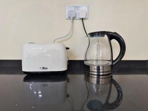 a blender and a toaster sitting on a counter at The Emerald Apartments Ibex Meanwood in Lusaka +141 photos