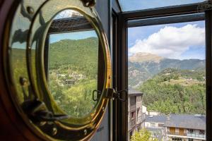 a window with a view of a mountain view at Gran Hogar Chic I 8 min de los remontes con balcón in La Massana