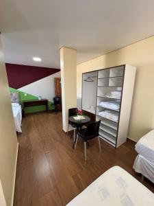 a room with a room with two beds and a table at Sumaúma Hotel in Tefé