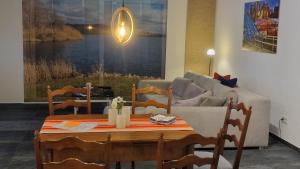 a living room with a table and a couch at Mitten im Saarland in Heusweiler