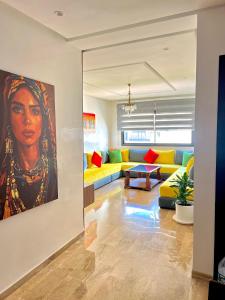 a living room with a painting of a woman at le Cocon in Agadir