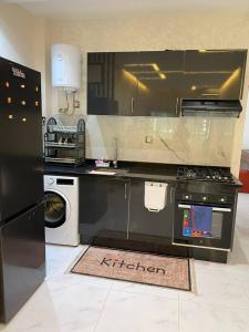 a kitchen with a black refrigerator and a dishwasher at Résidence al BASSLAM agadir in Agadir