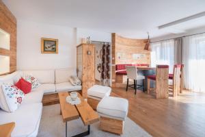 a living room with a white couch and a table at Sweethome Apple in Fiumes