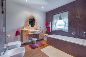 a bathroom with a large tub and a sink at Sweethome Apple in Fiumes +31 photos