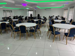 a room with tables and chairs and a man standing in the middle at Gold Rush Oasis in Johannesburg