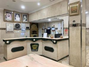 a restaurant with a counter in a room at Asus Al Taj Serviced Apartments in Baish