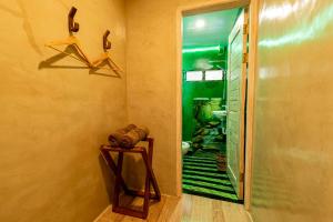 a bathroom with a walk in shower and a hallway at La Maison - Siquijor in Siquijor