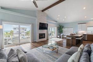 a living room with a couch and a fireplace at Aqua Vista l Beach Views I Pool Spa in Butler Beach