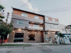 a building on a street in front of a building at Tariri Hotel in Pucallpa