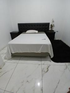 a bedroom with a bed with a black headboard at Tuly in Formosa