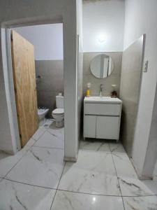 a bathroom with a sink and a toilet at Tuly in Formosa