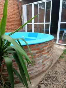 a pool in a brick wall next to a window at Tuly in Formosa