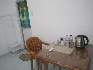a wooden table with a tea kettle on top of it at Sadew Villa in Anuradhapura