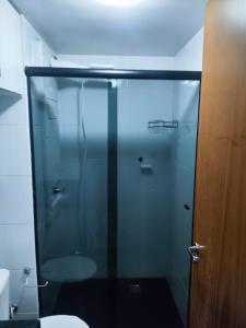 a glass shower in a bathroom with a toilet at Estrela Da Manhã Flat in Brasilia