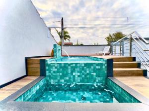 a swimming pool in the backyard of a house at Studio moderno com piscina 350m do mar in Piçarras