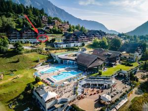 an aerial view of a resort with a swimming pool at Centre Thermal - Studio SUD avec grande terrasse in Ovronnaz