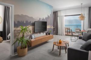 a living room with a tv on a wall at Olive Hill House - first floor in Slatine