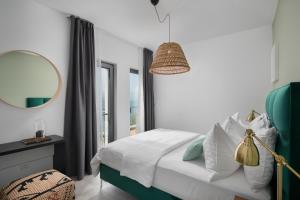 a bedroom with a bed with a mirror and a window at Olive Hill House - first floor in Slatine +21 photos