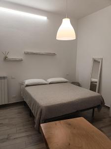 a bedroom with a bed and a lamp and a table at Palazzo Cavour in Trino