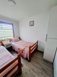 a bedroom with two beds and a window at Cabañas Ruben Dario 1 in Puerto Natales