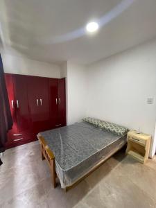 a bedroom with a bed and red cabinets at Marlu house in San Nicolás de los Arroyos
