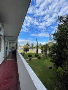 a balcony of a building with a view of a yard at Marlu house in San Nicolás de los Arroyos